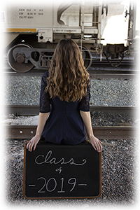 Picture of girl by train with suitcase